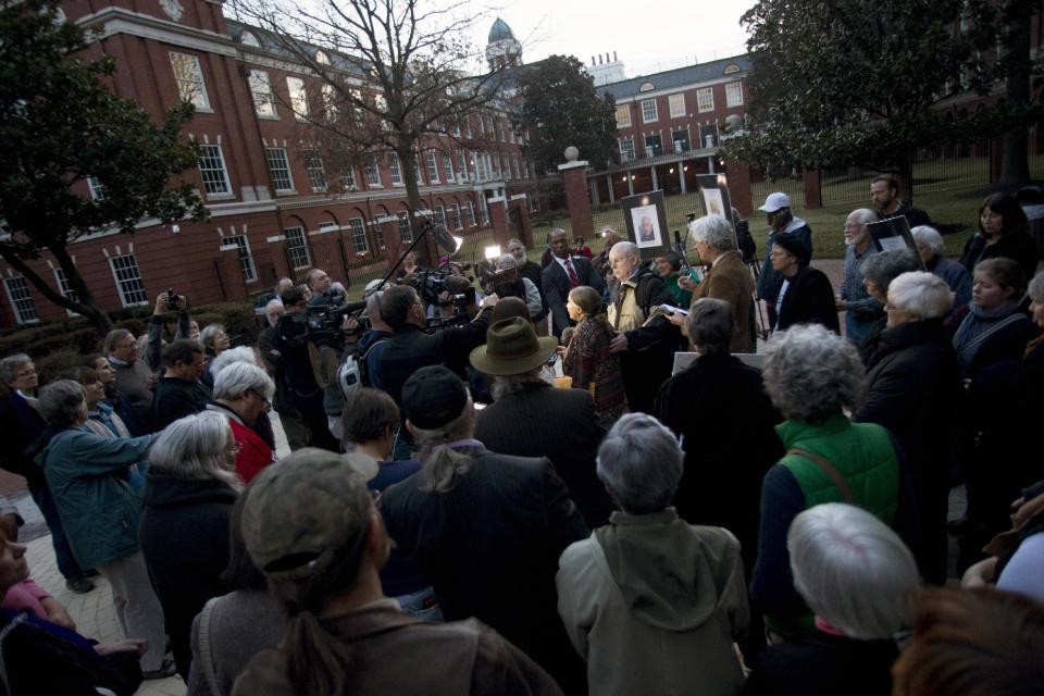 Supporters, reporters, and family gather around Michele Naar-Obed as she makes a statement concerning the sentencing of her husband Greg Boertje-Obed and two others for the role they played in a July 2012 break-in at the Y-12 National Security Complex in Knoxville, Tenn., Tuesday, Feb. 18, 2014. Sister Megan Rice, 84, was sentenced to nearly three years in prison and Michael Walli and Greg Boertje-Obed were sentenced to more than five years in prison. The break-in raised questions about the safekeeping at the facility that holds the nation's primary supply of bomb-grade uranium. (AP Photo/The Knoxville News Sentinel, Saul Young)