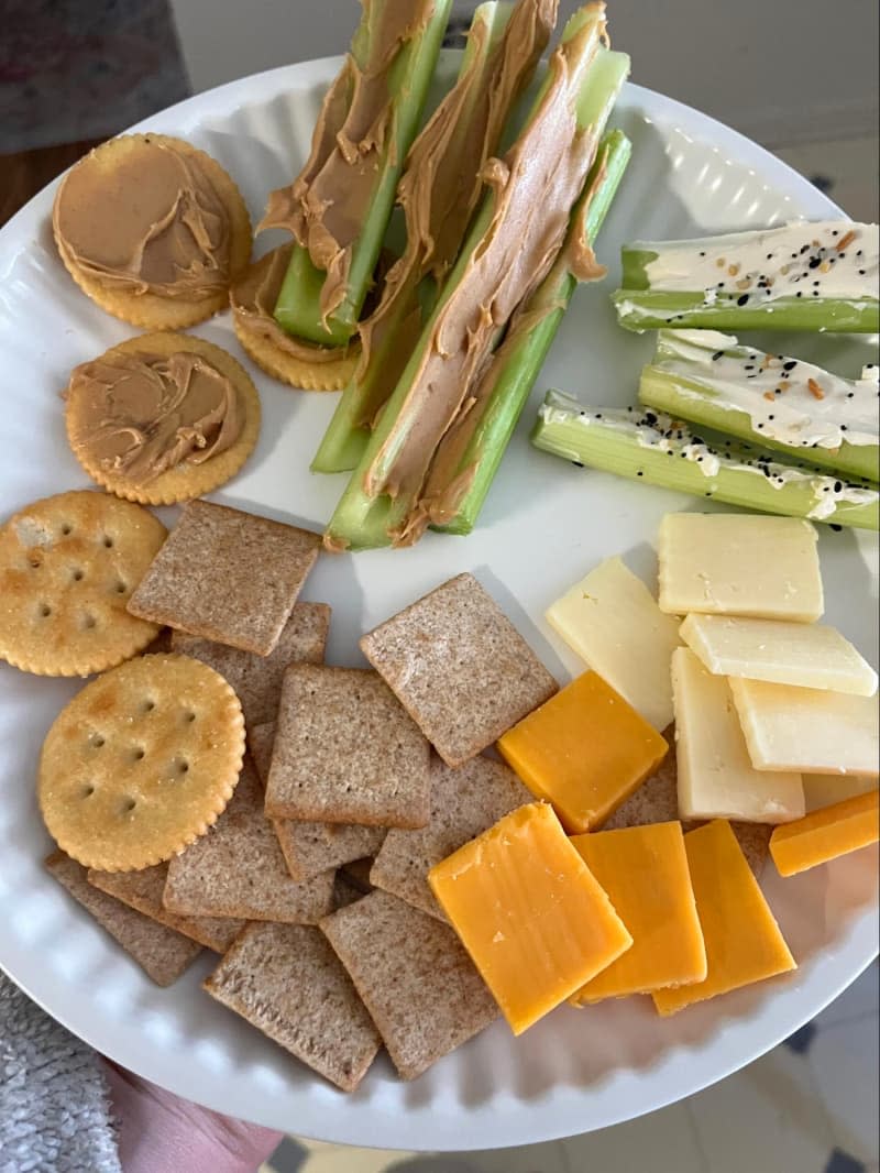 paper plate with snacks (celery with peanut butter, crackers, cheese)