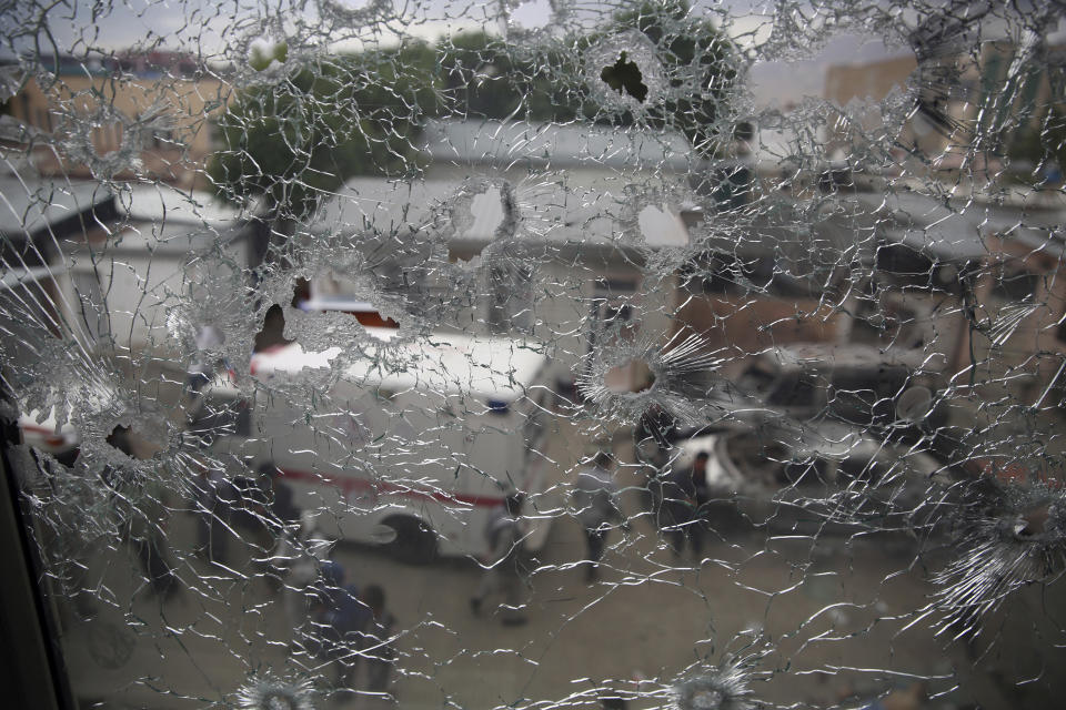 FILE-in this Tuesday, May 12, 2020, photo, security officers are seen through the shattered window of a maternity hospital after gunmen attacked, in Kabul, Afghanistan, The Geneva-based international health organization Medicins Sans Frontieres MSF– also known as Doctors Without Borders Tuesday closed its operations in the Afghan capital Kabul after a horrific attack on its maternity hospital in May. (AP Photo/Rahmat Gul, File)