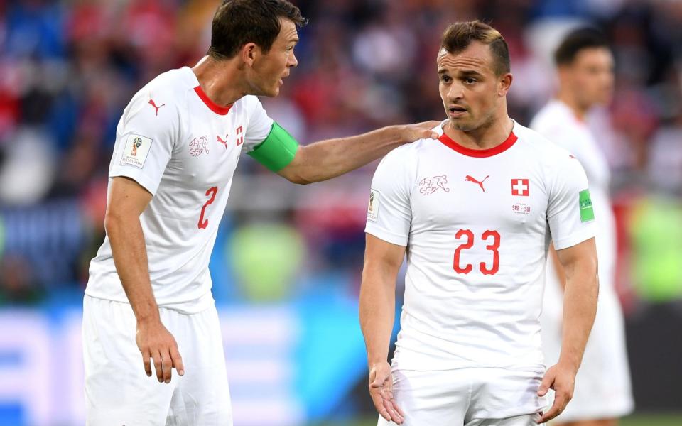 Stephan Lichtsteiner (left), the Swiss captain, will face disciplinary proceedings alongside Xherdan Shaqiri (right) and Granit Xhaka following Friday night's heated meeting between Switzerland and Serbia - Getty Images Europe