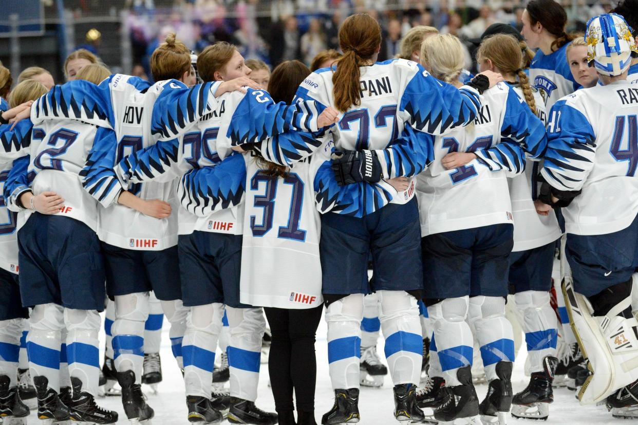 Finnish players wait for the referee's decision after Finland scored a game-winning overtime goal which was later disallowed during the IIHF Women's Ice Hockey World Championships final match between the United States and Finland in Espoo, Finland, on Sunday, April 14, 2019. (Mikko Stig/Lehtikuva via AP)
