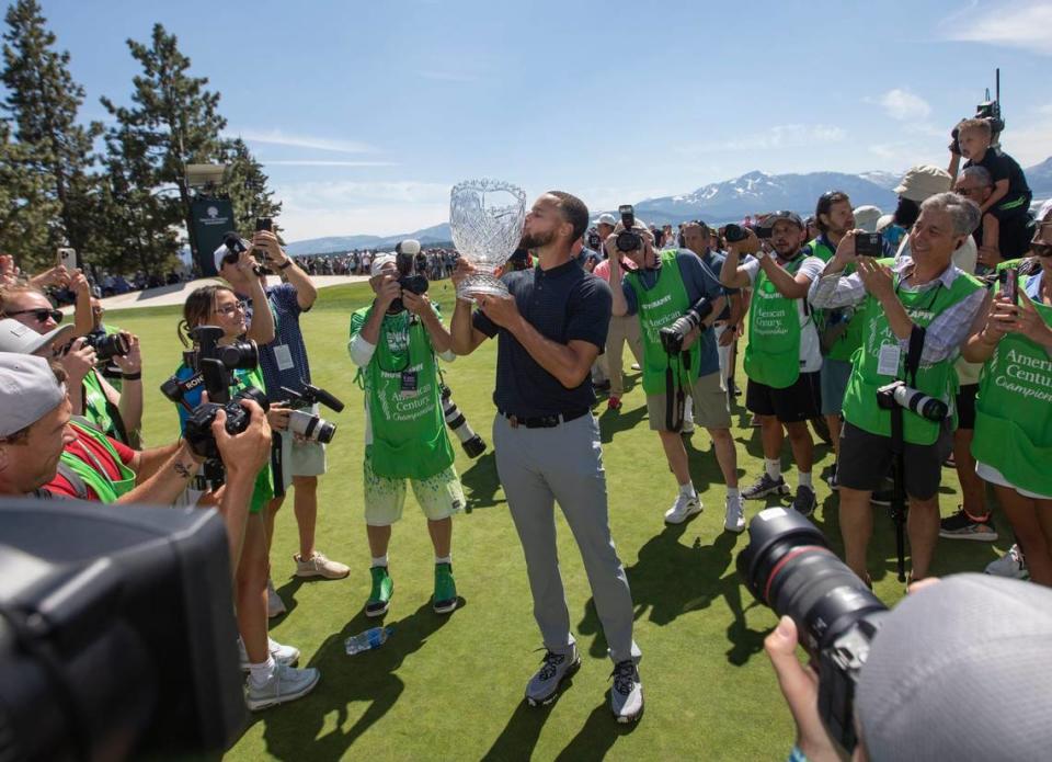Stephen Curry celebrates kissing the trophy after sinking the winning putt during the final round of the American Century Celebrity Championship golf tournament at Edgewood Tahoe Golf Course in Stateline, Nev., Sunday, July 16, 2023.