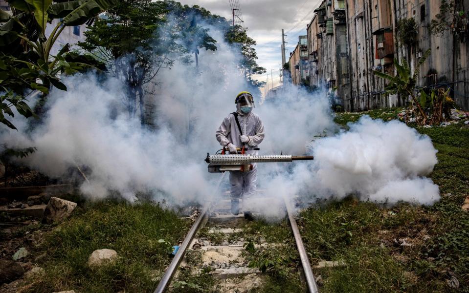 A health workers fumigates a slum in Manila against Covid-19 - Ezra Acayan/Getty Images