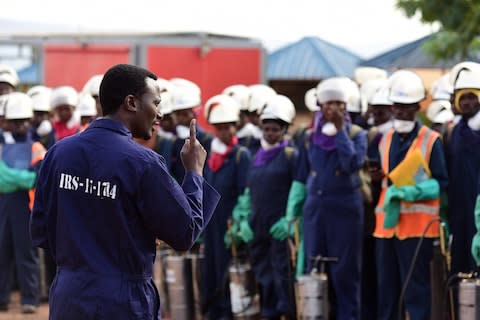 Health workers prepare to undertake a spraying campaign - Credit: Maggie Andresen&nbsp;