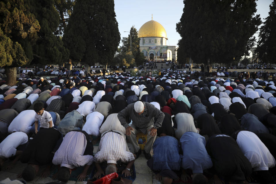 Muslims take part in Eid al-Fitr prayers at the Dome of the Rock Mosque in the Al-Aqsa Mosque compound in the Old City of Jerusalem, Thursday, May 13, 2021. Eid al-Fitr, festival of breaking of the fast, marks the end of the holy month of Ramadan. (AP Photo/Mahmoud Illean)