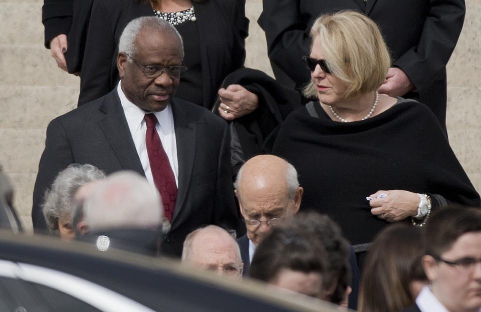 FILE - Supreme Court Associate Justice Clarence Thomas, left and his wife Virginia Thomas, right, leave the the Basilica of the National Shrine of the Immaculate Conception in Washington after attending funeral services of the late Supreme Court Associate Justice Antonin Scalia, on Feb. 20, 2016. Virginia Thomas sent weeks of text messages imploring White House Chief of Staff Mark Meadows to act to overturn the 2020 presidential election — furthering then-President Donald Trump's lies that the free and fair vote was marred by nonexistent fraud, according to copies of the messages obtained by The Washington Post and CBS News. (AP Photo/Pablo Martinez Monsivais, File)