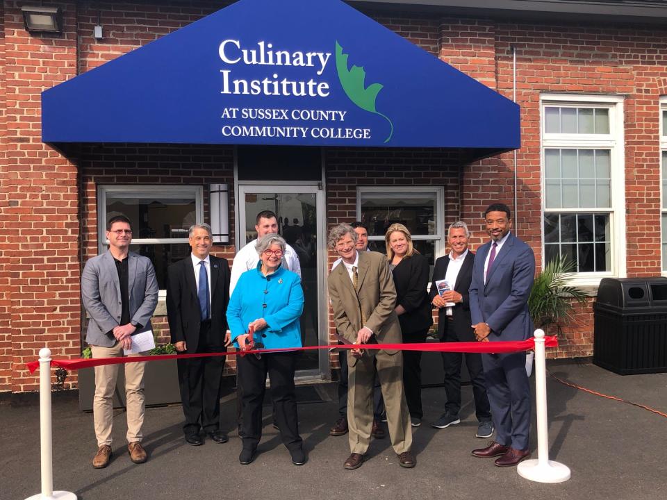 Lorraine Parker, former chair of the Sussex County Community College Board of Trustees, front left, and SCCC President Jon Connolly cut the ribbon to the college's Culinary Institute during the facility's grand opening event on Main Street in Newton Thursday, April 27, 2023.