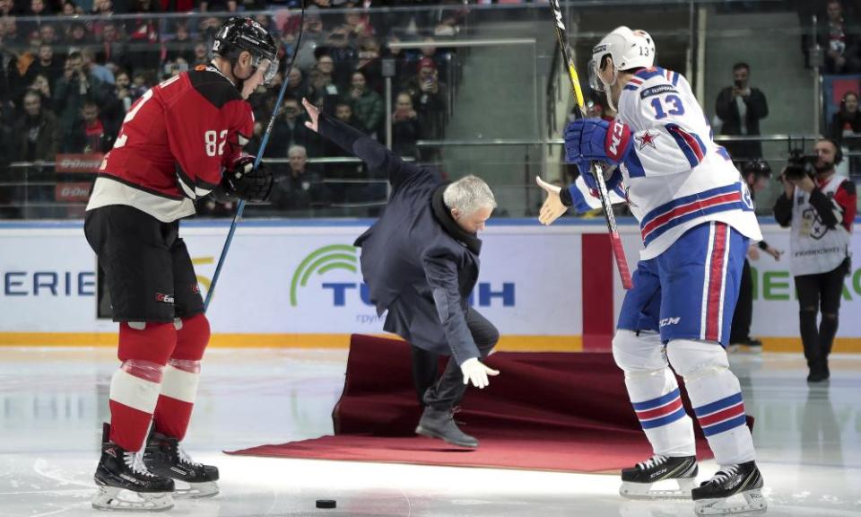 Former Manchester United coach Jose Mourinho falls after making the first puck drop at a Russian hockey game