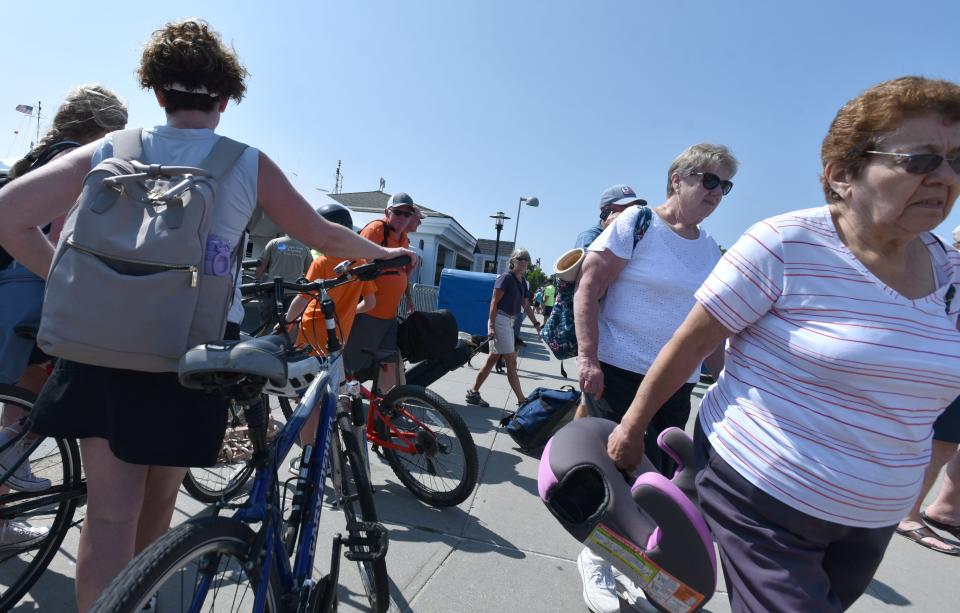 Arrivals from Nantucket on the right share space with departing bicyclists on the left on Wednesday at the Woods Hole, Martha's Vineyard and Nantucket Steamship Authority fast ferry terminal in Hyannis.