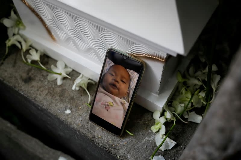 Burial of three-month old baby separated from jailed mother