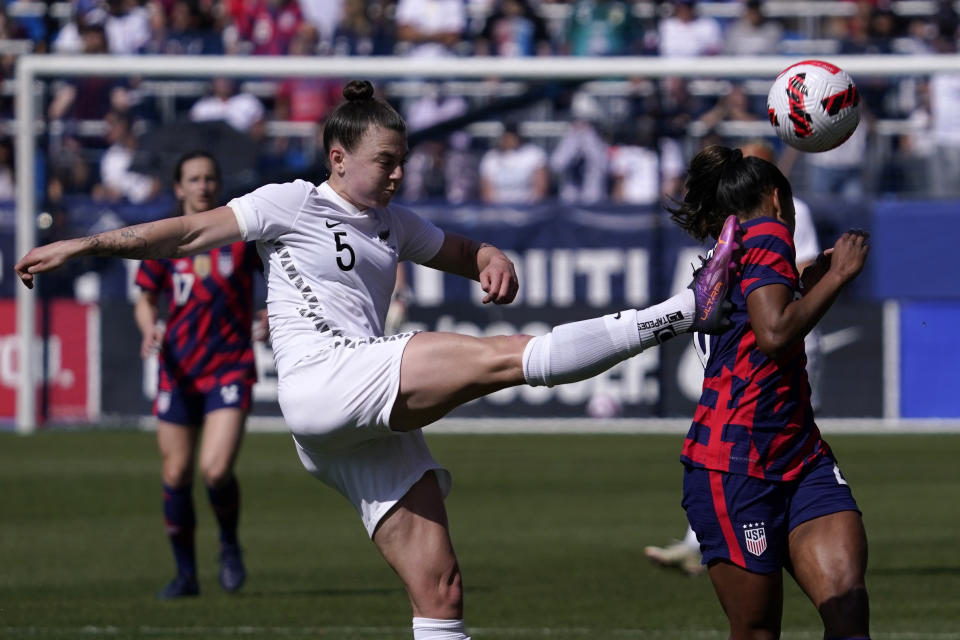 New Zealand defender Meikayla Moore, left, kicks the ball past United States midfielder Catarina Macario during the first half of the 2022 SheBelieves Cup soccer match Sunday, Feb. 20, 2022, in Carson, Calif. (AP Photo/Mark J. Terrill)