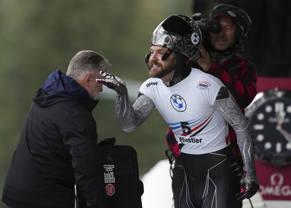 Andrew Blaser, of the United States, blows a kiss to a spectator after racing to a 14th place finish during the men's competition at the world cup skeleton event in Whistler, British Columbia, Thursday, Nov. 24, 2022. (Darryl Dyck/The Canadian Press via AP)