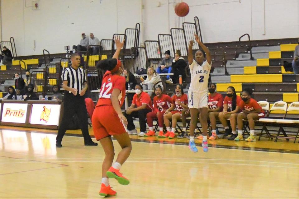 Paul VI sophomore Sharia Baynes fires a 3-pointer as Imhotep Charter Anise Geiger closes in too late