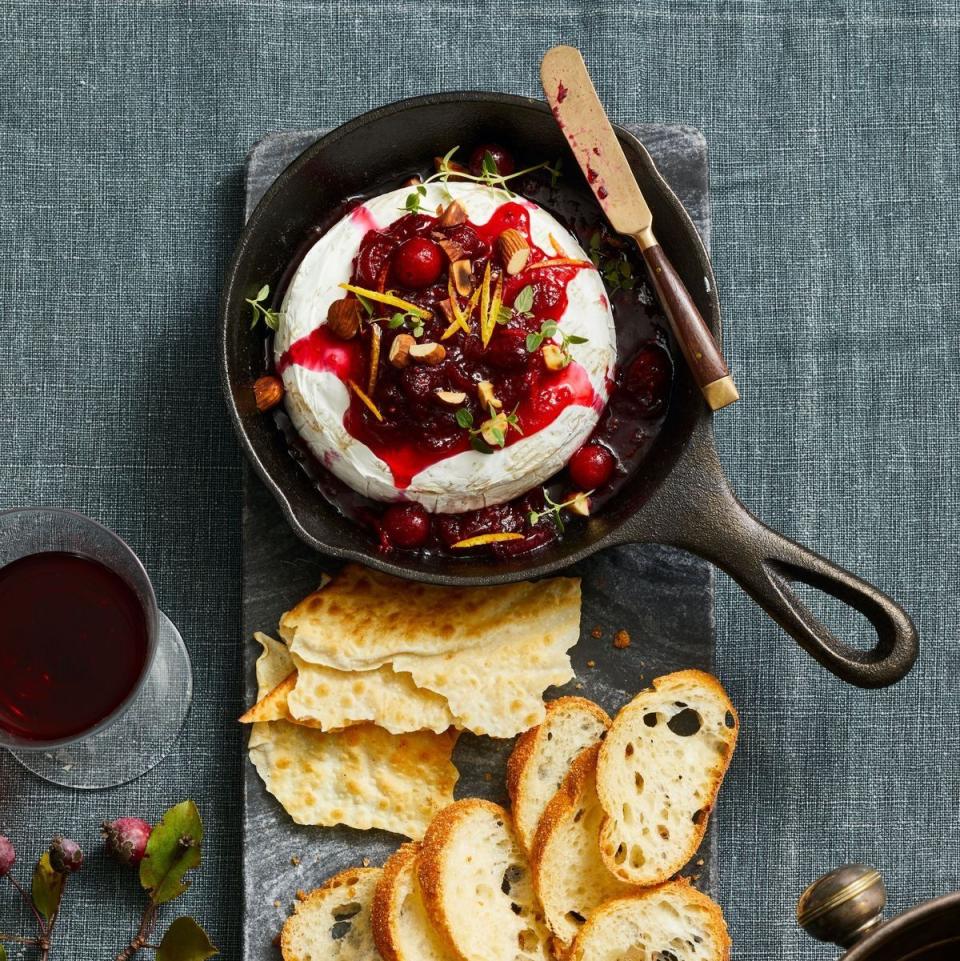 <p>A cheesy appetizer is always a crowd favorite! So why not wow guests with a melted Brie wheel that has cranberry syrup spooned over the top?</p><p>Get the <strong><a href="https://www.goodhousekeeping.com/food-recipes/a41887192/easy-cranberry-baked-brie-recipe/" rel="nofollow noopener" target="_blank" data-ylk="slk:Cranberry Baked Brie recipe;elm:context_link;itc:0;sec:content-canvas" class="link ">Cranberry Baked Brie recipe</a></strong>.</p>