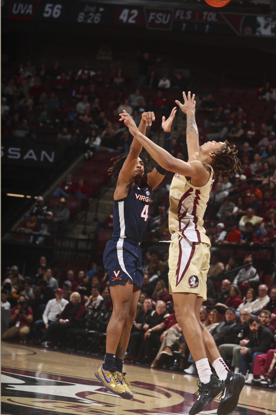 Virginia guard Armaan Franklin (4) shoots a 3-point basketover the defense of Florida State forward Cameron Corhen, right, in the second half of an NCAA college basketball game in Tallahassee, Fla., Saturday, Jan. 14, 2023. (AP Photo/Phil Sears)