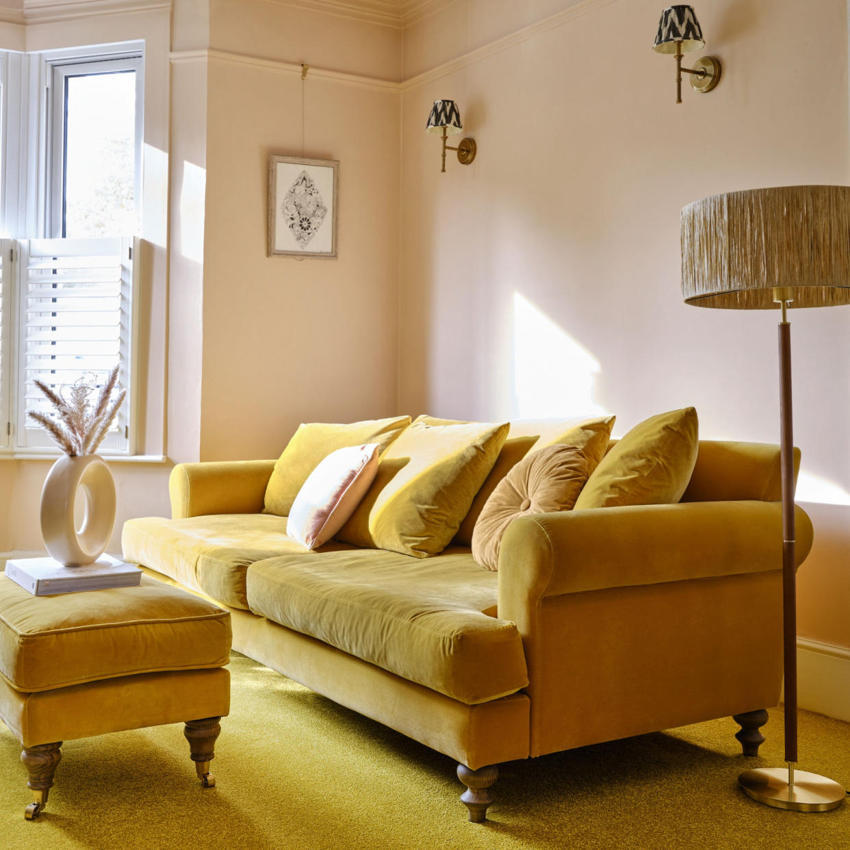  living room colour schemes, yellow and blush living room, yellow sofa and carpet, blush pink walls, shutters, wall lights  