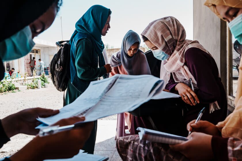 BAMYAN, AFGHANISTAN -- SEPTEMBER 23, 2022: Meena Ibrahimi, 20, center, and other students are preparing and studying for the Kankor exam at a private tutoring center in Bamyan, Afghanistan, Friday, Sept. 23, 2022. A year after the precipitous fall of the U.S.-backed republic and the TalibanOs ascension to power, many women across Afghanistan are grappling with the Islamic militantsO hard-line vision for the country and its plan to rewind the clock not only on their education but their very presence in public life. In the fall of last year, authorities allowed Afghan girls to enroll in primary schools and universities and promised to resume secondary education at the start of the new school year March 23. But that day, as high school girls streamed into classrooms, officials reversed course and postponed classes indefinitely until Oa comprehensive plan has been prepared according to Sharia and Afghan culture.O Last month, the Taliban government allowed graduating senior girls, including those who had been out of school since the republicOs collapse, to take the university placement exam known as the Kankor N but blocked off majors they deemed inappropriate for young women to pursue, including economics, engineering, journalism and even veterinary medicine. (MARCUS YAM / LOS ANGELES TIMES)