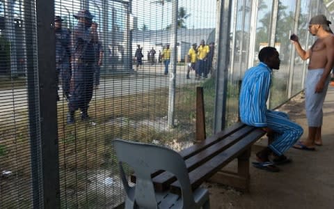 Asylum-seekers (right) at the Manus Island regional refugee processing centre - Credit: AFP