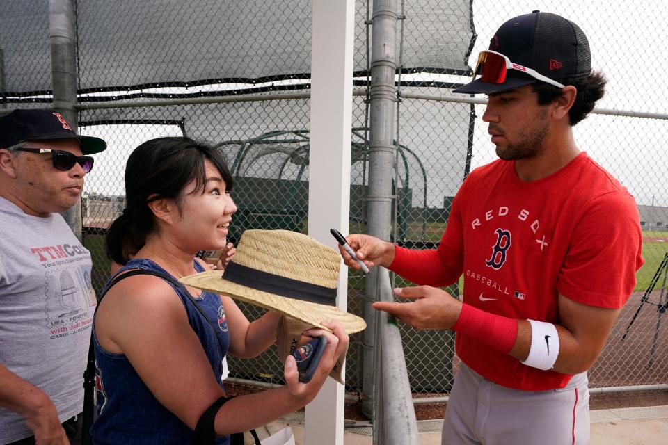 Boston's Marcelo Mayer signs autographs during baseball spring training at Jet Blue Park Wednesday March 16, 2022, in Fort Myers, Fla.