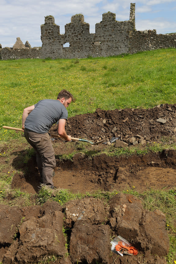 An archeologist digs through the rocky field near Dunluce Castle. The town founded by the MacDonnells in 1608 thrived until 1642, when it burnt down after a conflict. The town never recovered, and people abandoned it in the 1680s, according to