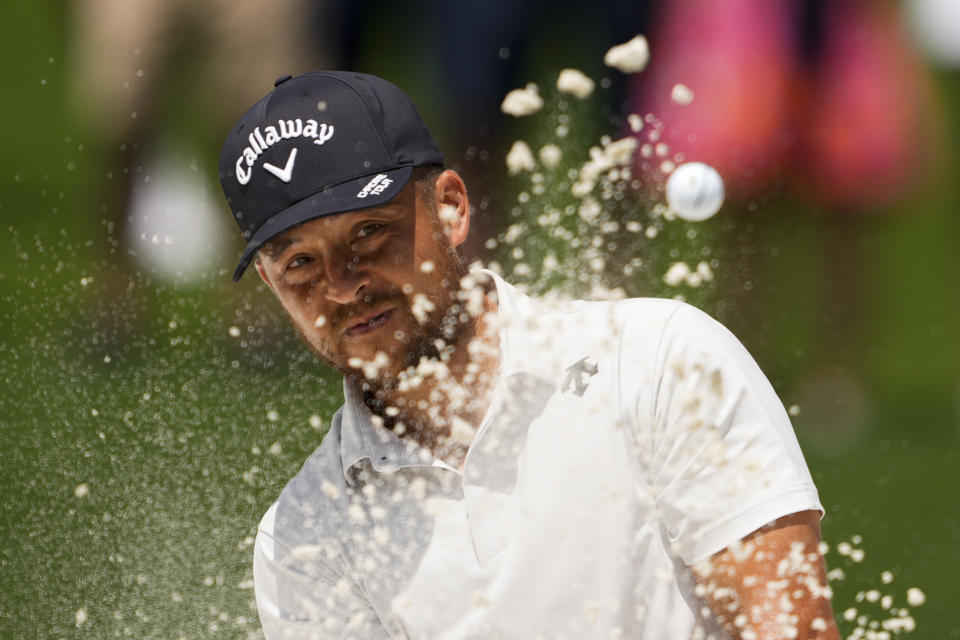 Xander Schauffele hits from the bunker on the fourth hole during the third round of the Wells Fargo Championship golf tournament at the Quail Hollow Club Saturday, May 11, 2024, in Charlotte, N.C. (AP Photo/Chris Carlson)