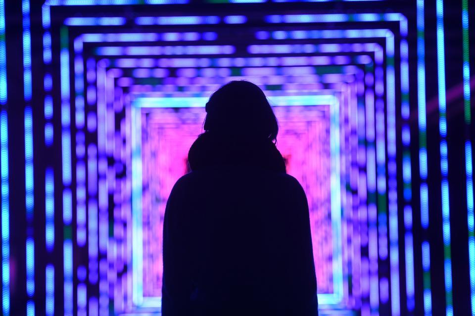 <p>A visitor stares at one of the colourful artworks (SWNS) </p>