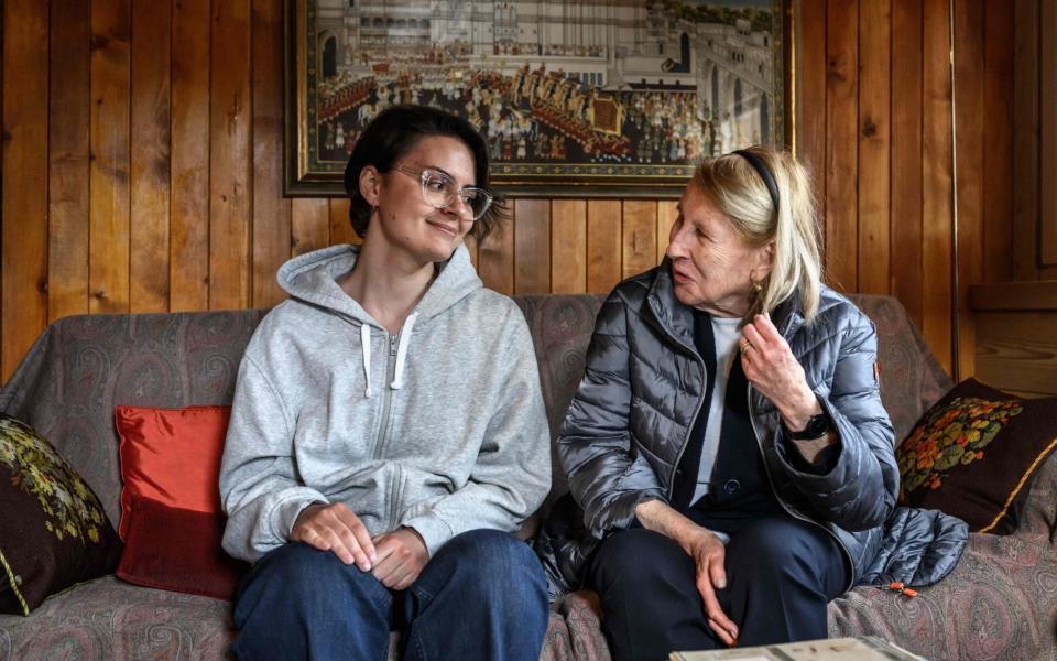 Leo Tolstoy's great-granddaughter Marta Albertini (R) speaks with Anastasia Sheludko, a Ukrainian refugee. - Fabrice Coffrini/AFP