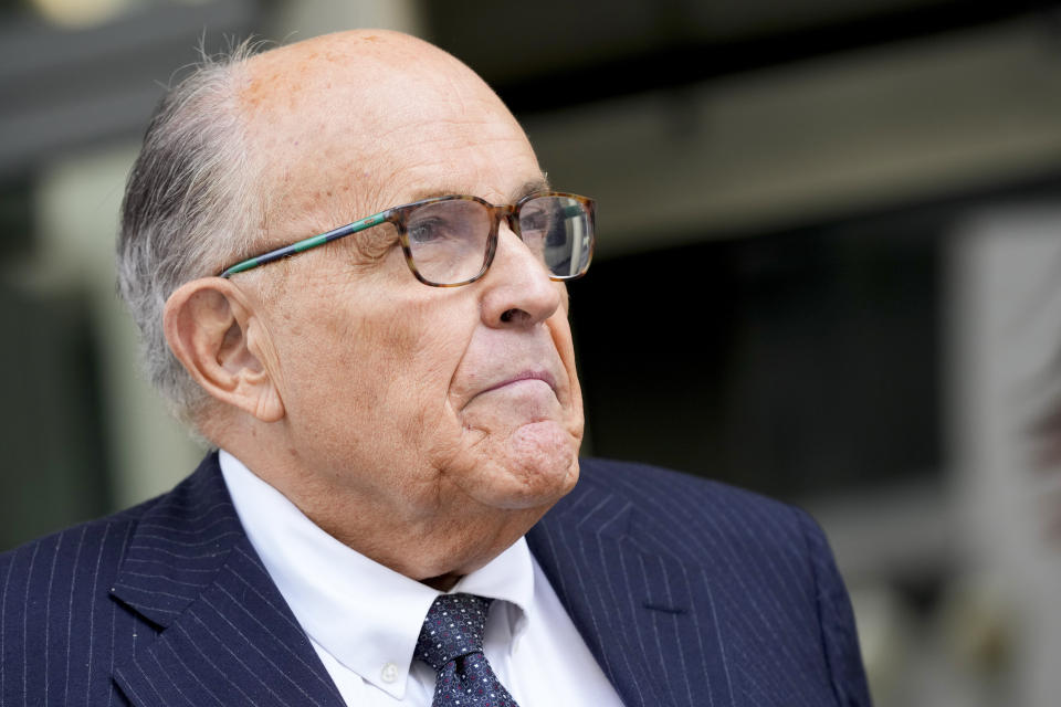 FILE - Rudy Giuliani speaks with reporters as he departs the federal courthouse, Friday, May 19, 2023, in Washington. A review panel says former New York Mayor Rudolph Giuliani should be disbarred in Washington for how he handled litigation challenging the 2020 election on behalf of then-President Donald Trump. (AP Photo/Patrick Semansky, File)