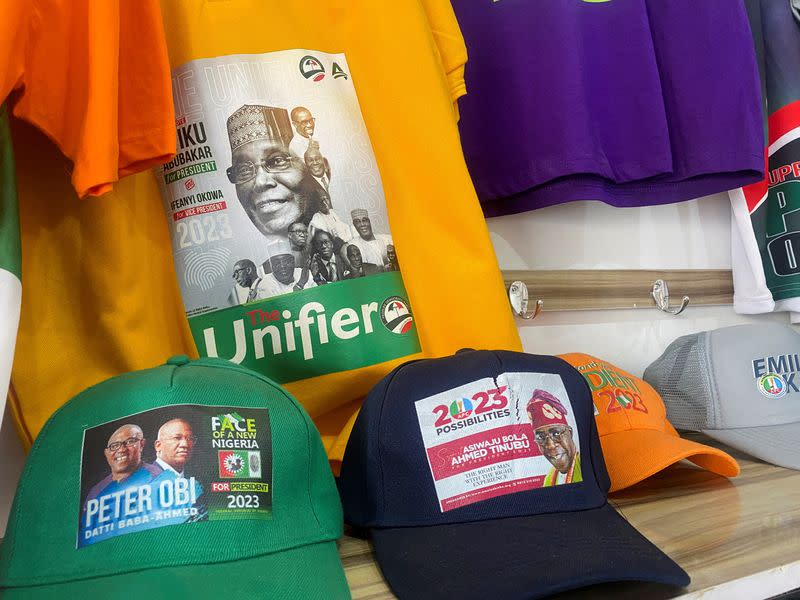 Branded T-shirts and baseball caps with images of Nigerian presidential candidates are displayed at a shopping center in Abuja