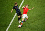 <p>Luka Modric in action with Russia’s Aleksandr Golovin </p>