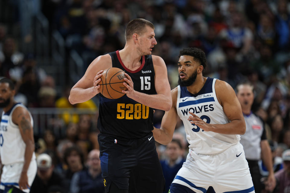 Denver Nuggets center Nikola Jokic (15) and Minnesota Timberwolves center Karl-Anthony Towns (32) in the second half of Game 2 of an NBA basketball second-round playoff series Monday, May 6, 2024, in Denver. (AP Photo/David Zalubowski)