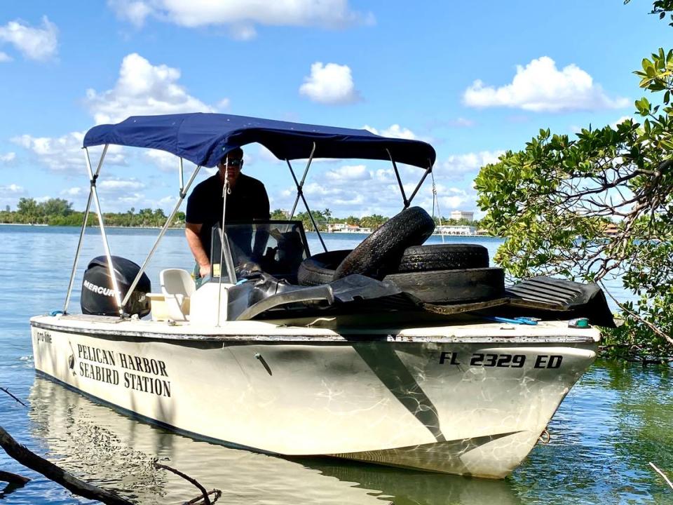 Christopher Boykin with some of the 1.4 tons of trash his crew collected on Bird Key, a private island in Biscayne Bay.