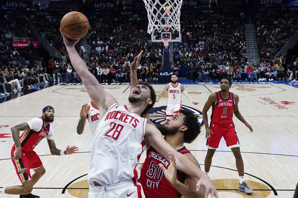 Houston Rockets center Alperen Sengun (28) goes to the basket against New Orleans Pelicans forward Jeremiah Robinson-Earl (50) in the second half of an NBA basketball game in New Orleans, Saturday, Dec. 23, 2023. The Rockets won 106-104. (AP Photo/Gerald Herbert)