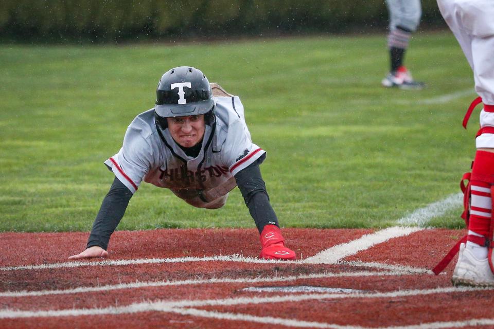 Thurston’s Easton McDonald dives safely into home plate to score as the Thurston Colts defeated the North Eugene Highlanders 9-0 Wednesday, April 12, 2023 at North Eugene High School.