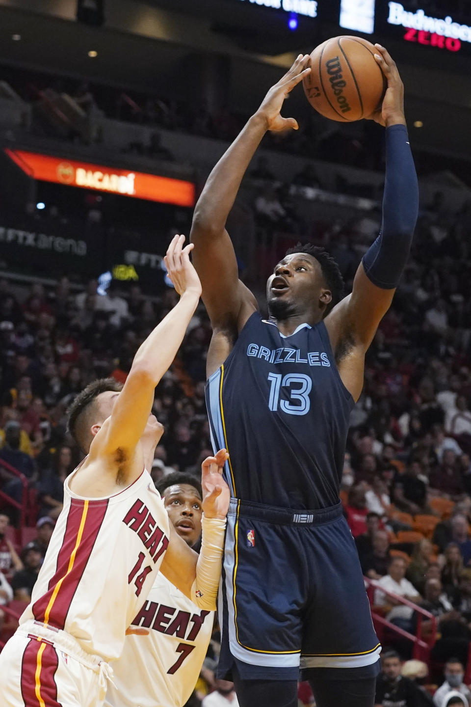 Memphis Grizzlies forward Jaren Jackson Jr. (13) drives to the basket over Miami Heat guards Tyler Herro (14) and guard Kyle Lowry (7) during the second half of an NBA basketball game, Monday, Dec. 6, 2021, in Miami. (AP Photo/Marta Lavandier)