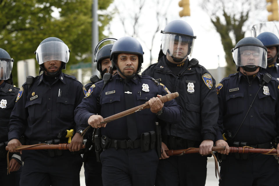 Baltimore Police officers in riot gear walk toward protestors along Reisterstown Road near Mondawmin Mall, April 27, 2015 in Baltimore, Maryland. A group of young protestors clashed with police in the streets near Mondawmin Mall in the afternoon following Freddie Gray's funeral. (Drew Angerer/Getty Images)