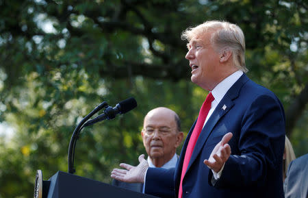 FILE PHOTO: U.S. President Donald Trump announces the United States-Mexico-Canada Agreement (USMCA) as U.S. Commerce Secretary Wilbur Ross looks on during a news conference in the Rose Garden of the White House in Washington, U.S., October 1, 2018. REUTERS/Leah Millis/File Photo