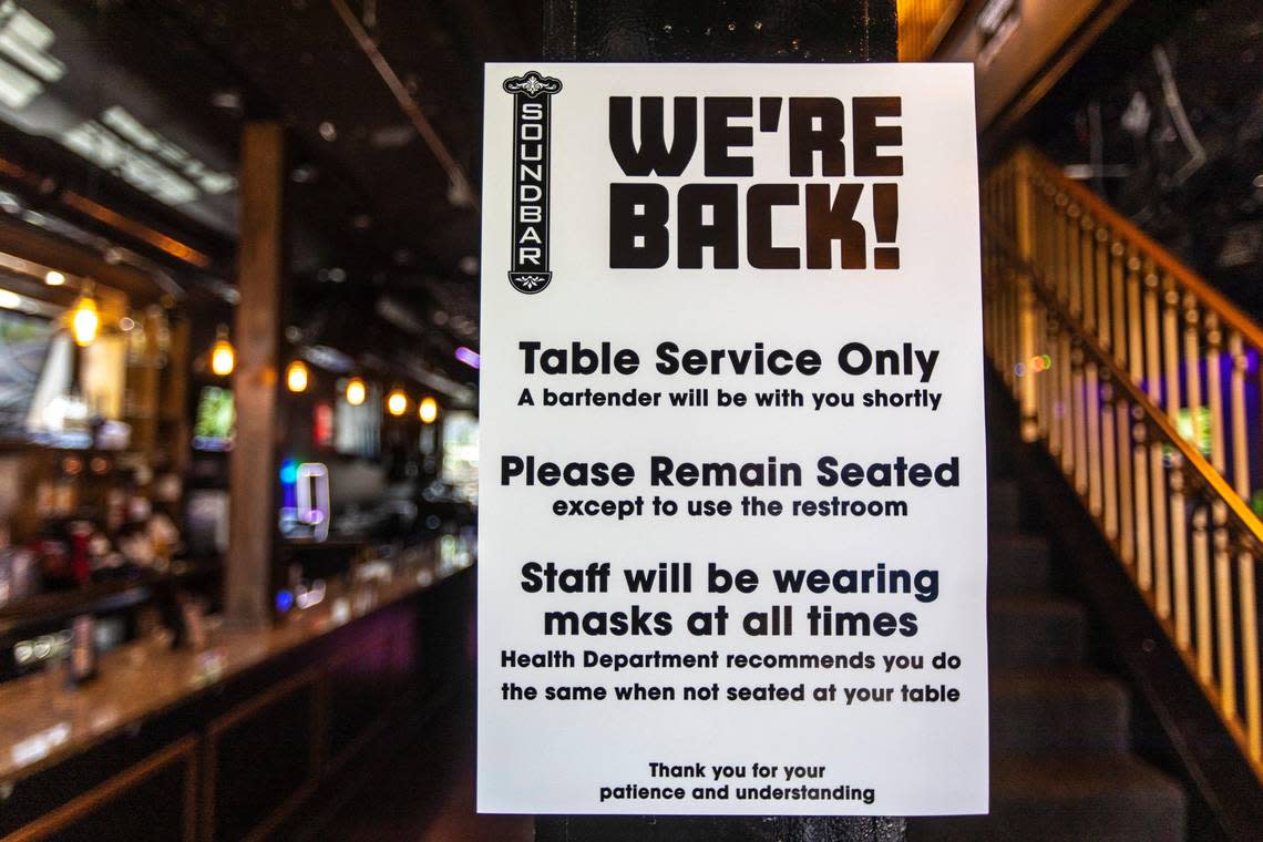 Signs greet patrons, advising them of new policies, near the entrance of Soundbar, at 208 South Limestone in Lexington, Ky., on Thursday, May 28, 2020.