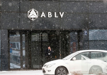 FILE PHOTO: A security guard speaks on her mobile phone at the head office of the ABLV Bank in Riga, Latvia February 18, 2018. REUTERS/Ints Kalnins/File Photo