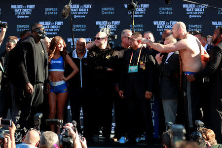 Boxing - Deontay Wilder & Tyson Fury Weigh-In - Los Angeles Convention Center, Los Angeles, United States - November 30, 2018 Tyson Fury and Deontay Wilder during the head to head after the weigh in Action Images via Reuters/Andrew Couldridge