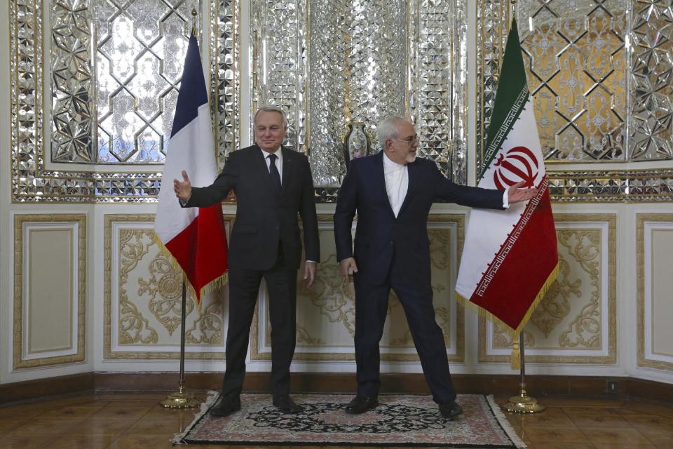 Iranian Foreign Minister Mohammad Javad Zarif, right, and his French counterpart Jean-Marc Ayrault, arrive for their meeting, in Tehran, Iran, Tuesday, Jan. 31, 2017. At a press conference following the meeting, Zarif refused to confirm that the country conducted a missile test, saying Iran's missile program is not part of a 2015 nuclear deal between his country and world powers. The White House said Monday it is studying the details of an Iranian ballistic missile test. A U.S. defense official said Monday that the missile test ended with a "failed" re-entry into earth's atmosphere. (AP Photo/Vahid Salemi)