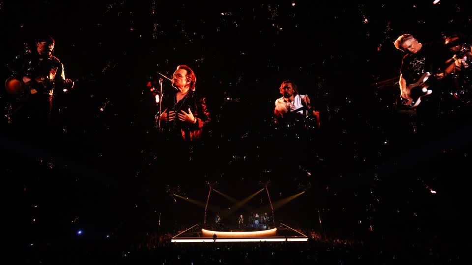 Enormous live images of Bono, The Edge, Adam Clayton and Bram van den Berg of U2 are projected on the screen. - Kevin Mazur/Getty Images/Live Nation