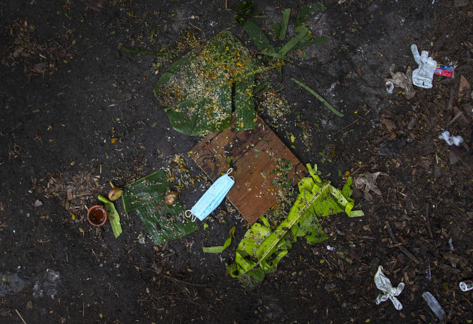 Banana leaves used during the last rituals of a deceased COVID-19 victim lie in a cremation ground in Gauhati, India, Friday, July 2, 2021. The personal belongings of cremated COVID-19 victims lie strewn around the grounds of the Ulubari cremation ground in Gauhati, the biggest city in India’s remote northeast. It's a fundamental change from the rites and traditions that surround death in the Hindu religion. And, perhaps, also reflects the grim fears grieving people shaken by the deaths of their loved ones — have of the virus in India, where more than 405,000 people have died. (AP Photo/Anupam Nath)