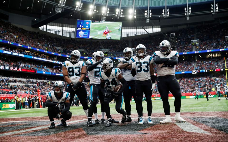 Carolina Panthers players strike a pose after an interception on the very first play - Action Images via Reuters