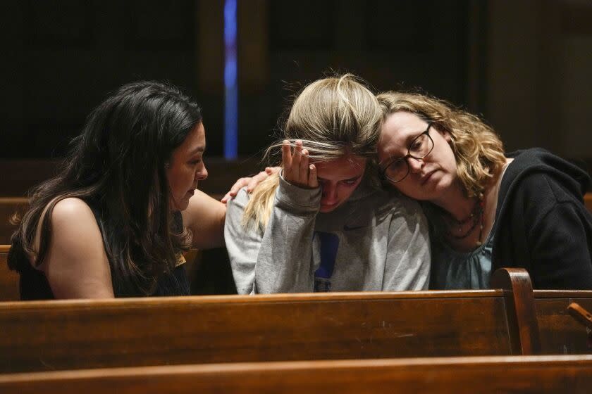 Parishioners participate in a community vigil at Belmont United Methodist Church in the aftermath of school shooting in Nashville, Monday, March 27, 2023, in Nashville, Tenn. Nashville police identified the victims in the private Christian school shooting Monday as three 9-year-old students and three adults in their 60s, including the head of the school. (AP Photo/John Bazemore)