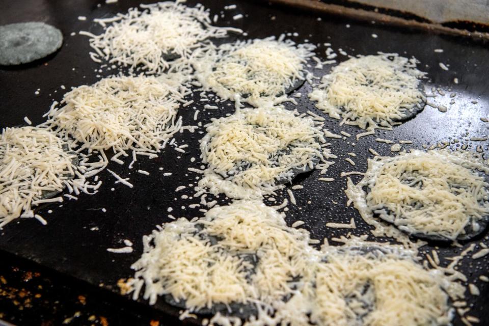 Above, a griddle with piles of shredded queso at the taqueria's new brick and mortar location in Highland Park.