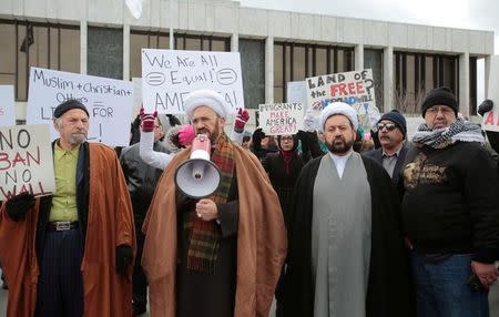 Imam Mohammad Ali Elahi (2ndL) talks about a temporary travel ban signed by U.S. President Donald Trump in an executive order during a protest in Dearborn, Michigan, U.S., January 29, 2017. REUTERS/Rebecca Cook