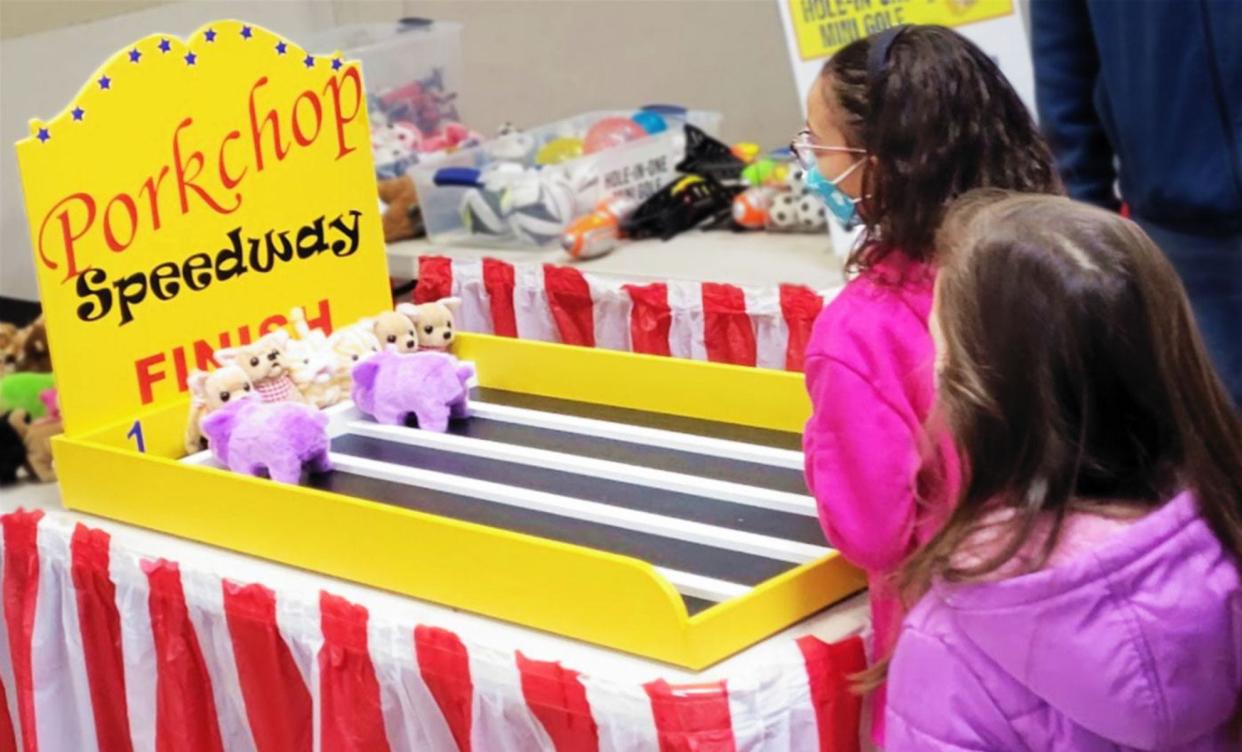 Young competitors vie for a prize in the Porkchop Speedway game at last year's Columbus Winter Carnival.