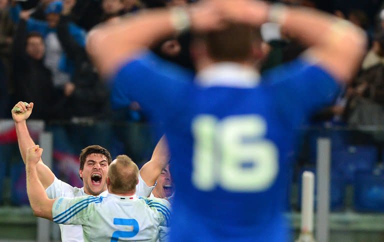 Italy’s winger Giovanbattista Venditti celebrates with teammate, hooker Leonardo Ghiraldini, after their Six Nations rugby union match vs France, in Rome's Olimpic Stadium, on February 3, 2013. Italy won 23-18 and play Scotland next, at Murrayfield, on Saturday
