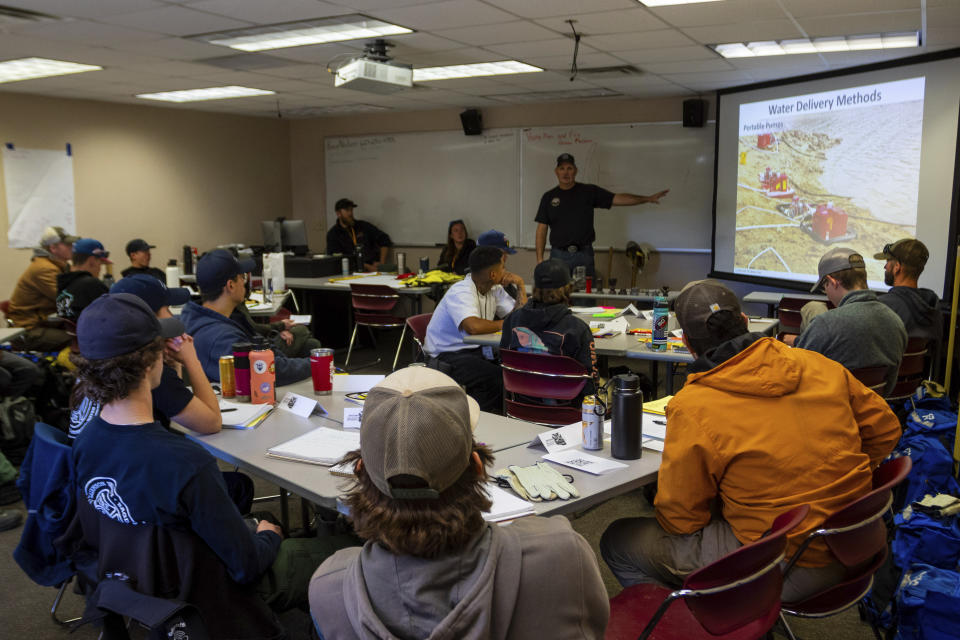 Wildfire academy students gather for instruction in a classroom, Monday, March 11, 2024, in Prescott, Ariz. Forecasters are warning that the potential for wildfires will be above normal in some areas across the United States over the coming months as temperatures rise and rain becomes sparse. (AP Photo/Ty ONeil)